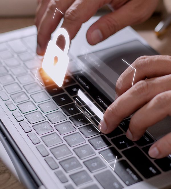 Close-up Of A Person's Hand typing on laptop with lock sign